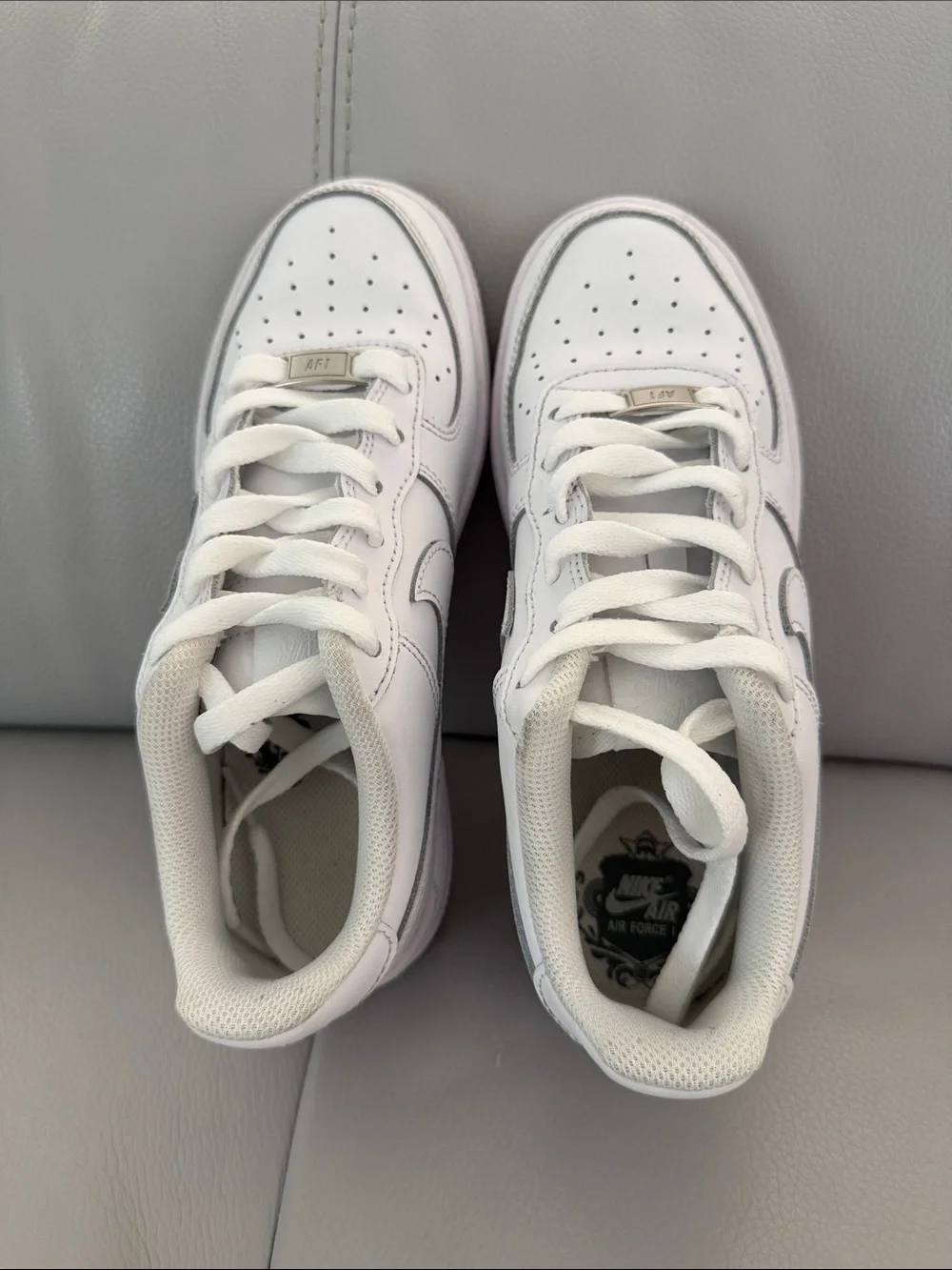 Nike Kids White Leather Sneakers with Subtle Silver Accents